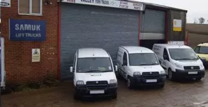 company vans lined up outside workshop